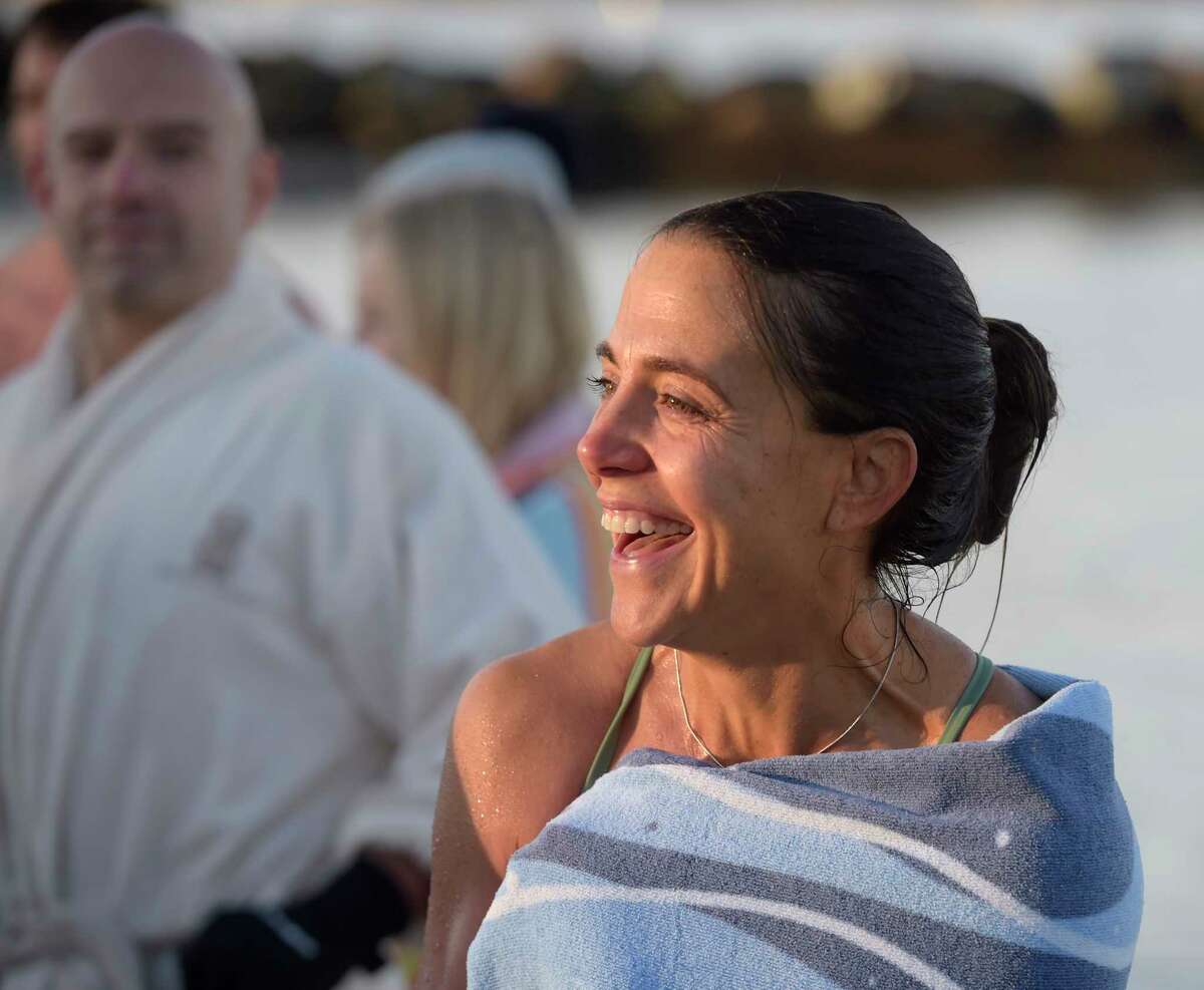 Jen Eldredge, of Darien, was all smiles after participating in a polar plunge at Pear Tree Point Beach. The plunge, organized by Carozza Fitness owner Michael Carozza, benefited Animals R Us. Sunday, January 1, 2023, Darien, Conn.