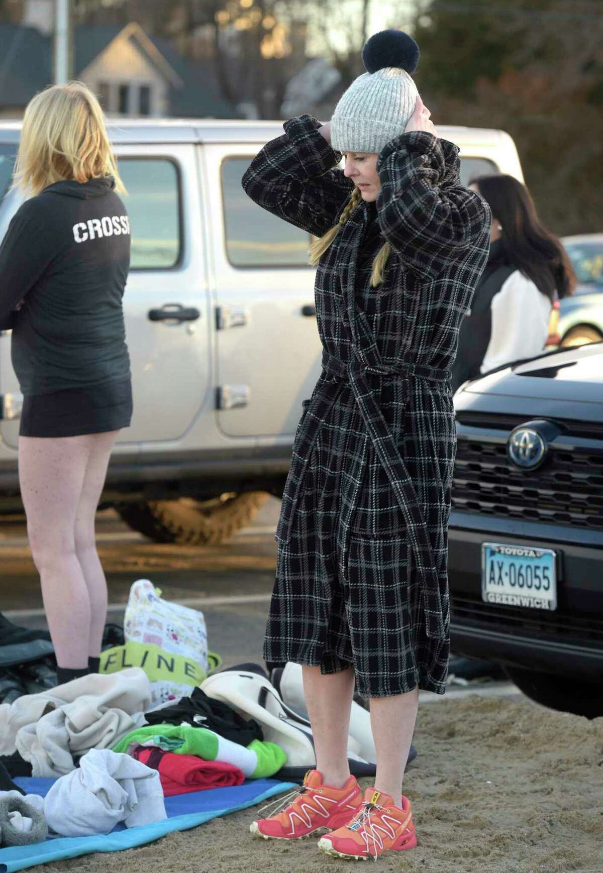 Victoria Marsh, of Stamford, gets ready to participate in a polar plunge at Pear Tree Point Beach. The plunge, organized by Carozza Fitness owner Michael Carozza, benefited Animals R Us. Sunday, January 1, 2023, Darien, Conn.