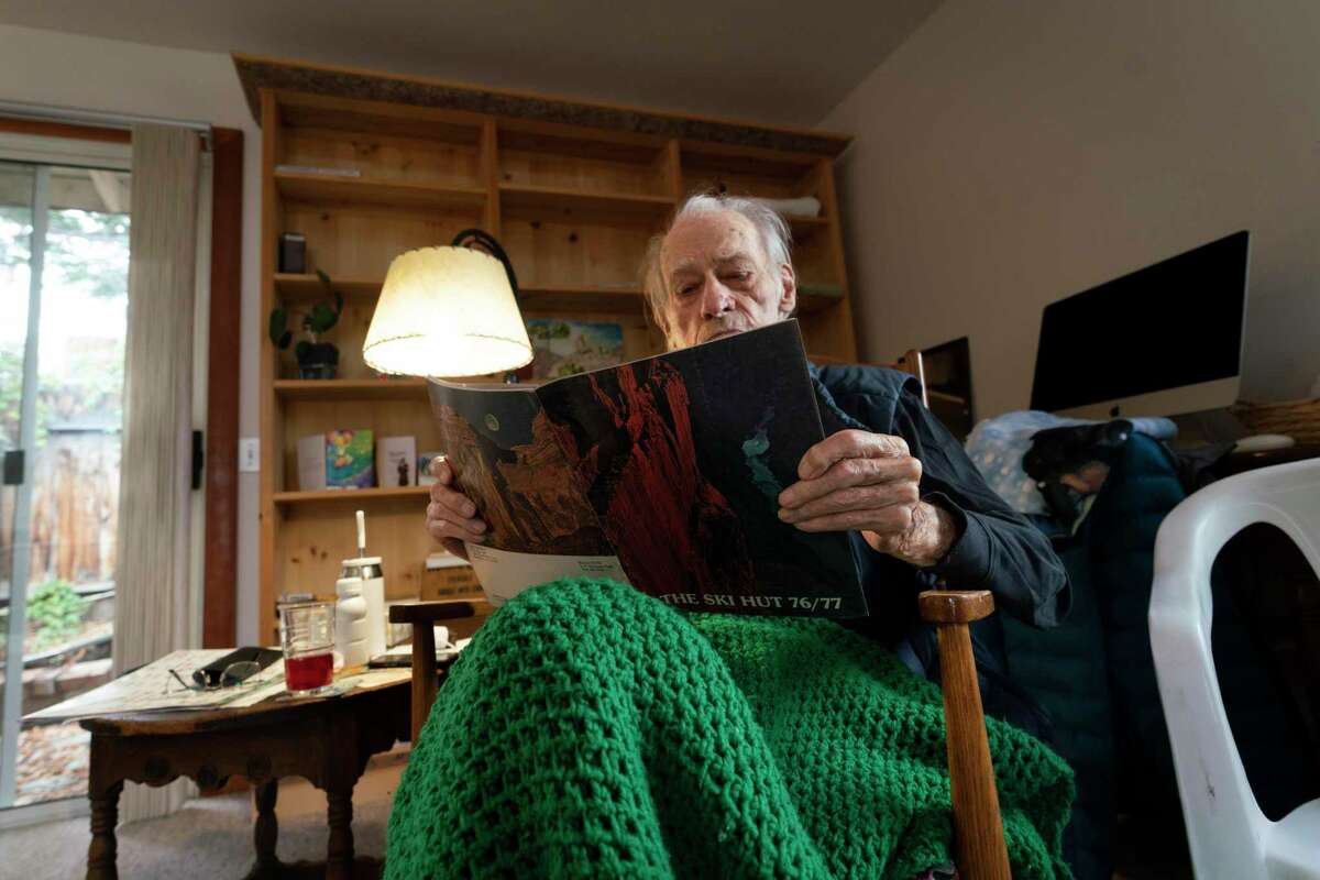 Allen Steck, a renowned mountaineer and former manager of the Kit Hut, looks at a 1976 catalog from the defunct Berkeley store at his home in Bishop (Inyo County).