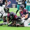 HOUSTON, TX - DECEMBER 12: Houston Texans wide receiver Nico Collins (12)  and Houston Texans tight end Jordan Akins (88) return to the locker room  after the end of the first half