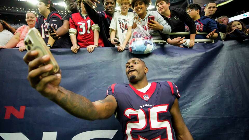 Houston Texans cornerback Desmond King II (25) poses for a selfie with Texans fans after the Texans 31-3 loss to the Jacksonville Jaguars in an NFL football game Sunday, Jan. 1, 2023, in Houston.