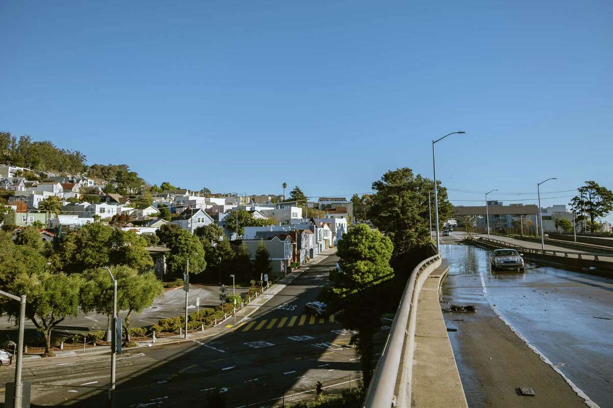 A car stopped after passing the flooded Monterey exit of Highway 280 towards the Glenn Park District of San Francisco, California, on Sunday, January 1, 2022.