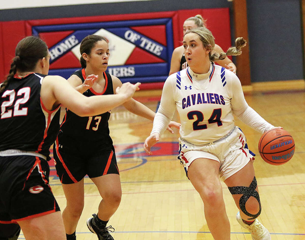 Carlinville's Isabella Tiburzi (24) looks to pass while Gillespie's Delaney Taylor and Emily Schoen (22) defend last week in the third-place game at the Carlinville Tournament.