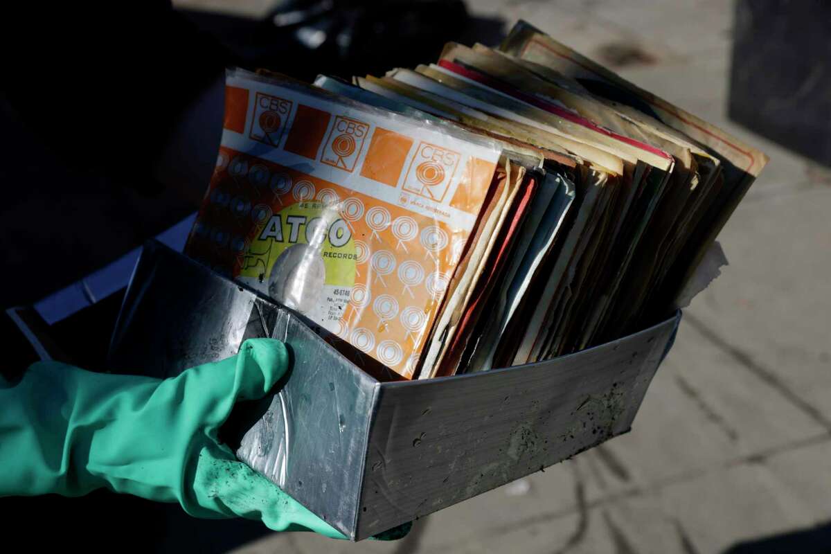 Drenched vinyl records are among many items damaged by dramatic flooding at the Pink Onion in San Francisco.
