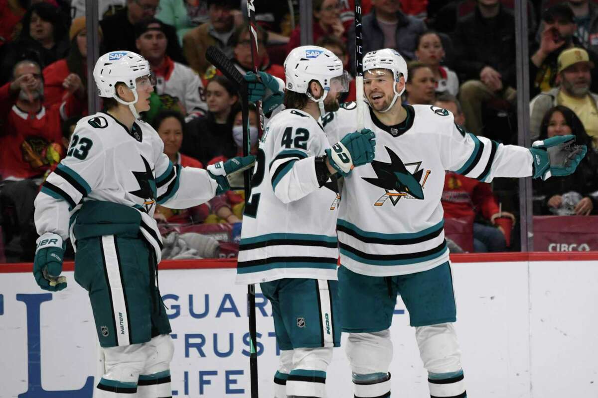 San Jose’s Jonah Gadjovich (42) celebrates with teammates Tomas Hertl (right) and Oskar Lindblom after scoring the Sharks’ first goal in the second period against the Blackhawks.