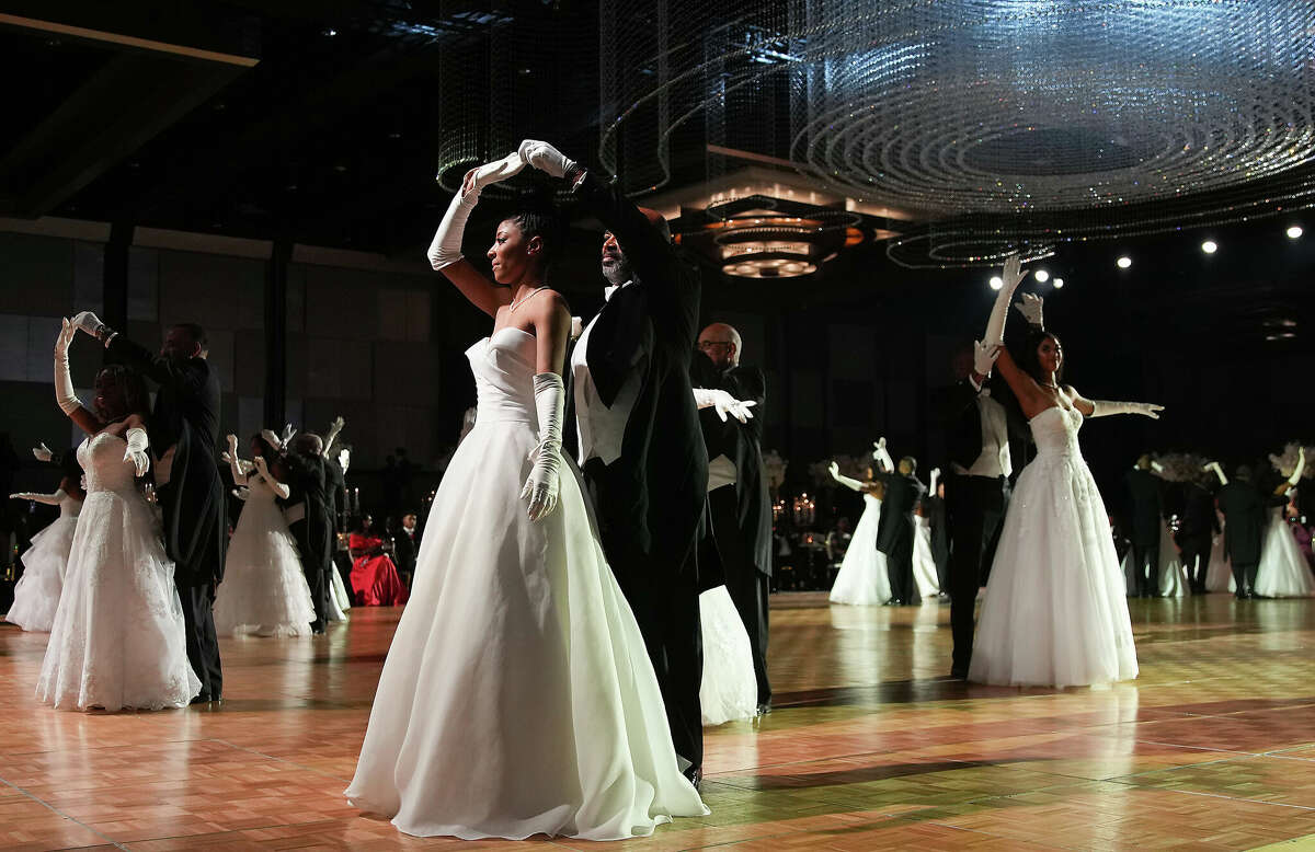Debutantes dance with their fathers during the Houston Chapter's 32nd annual Jack & Jill Debutante Ball at Hilton Americas Houston on Thursday, Dec. 29, 2022.