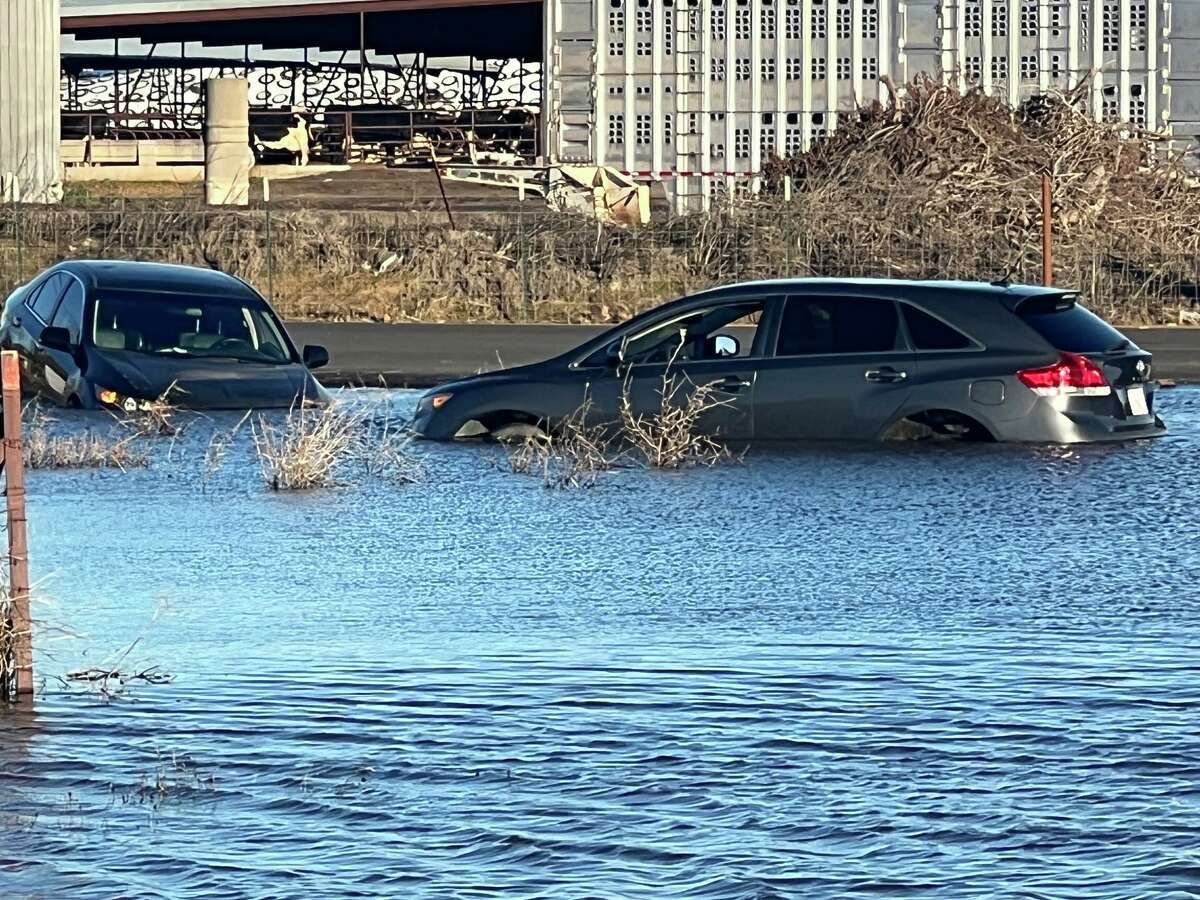 A car was stuck in a puddle covering Highway 99 on January 1 after an atmospheric river flooded Northern California on December 30-31, 2022.