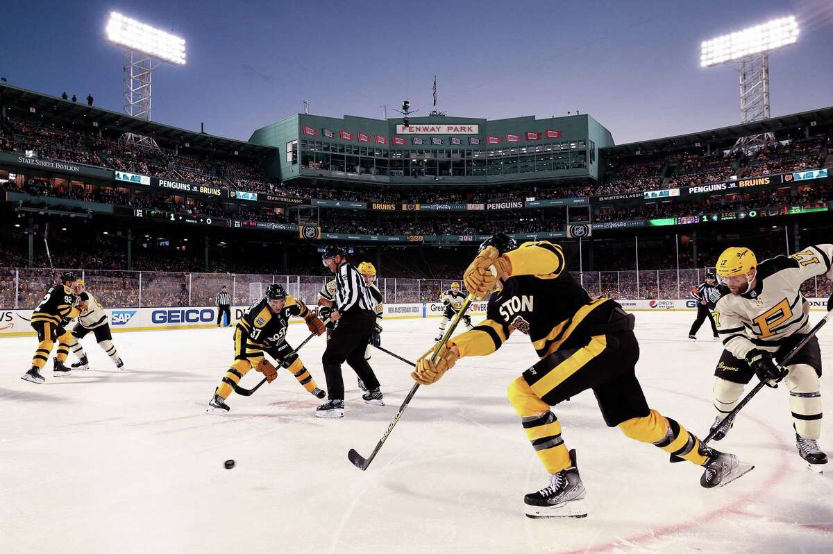 The temperatures were in the upper 40s when the Pittsburgh Penguins (in white) visited the Boston Bruins at Fenway Park.
