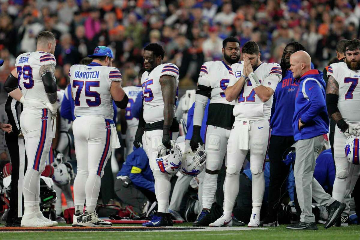 Buffalo Bills quarterback Josh Allen (17) pauses as Damar Hamlin is examined during the first half of an NFL football game against the Cincinnati Bengals, Monday, Jan. 2, 2023, in Cincinnati.