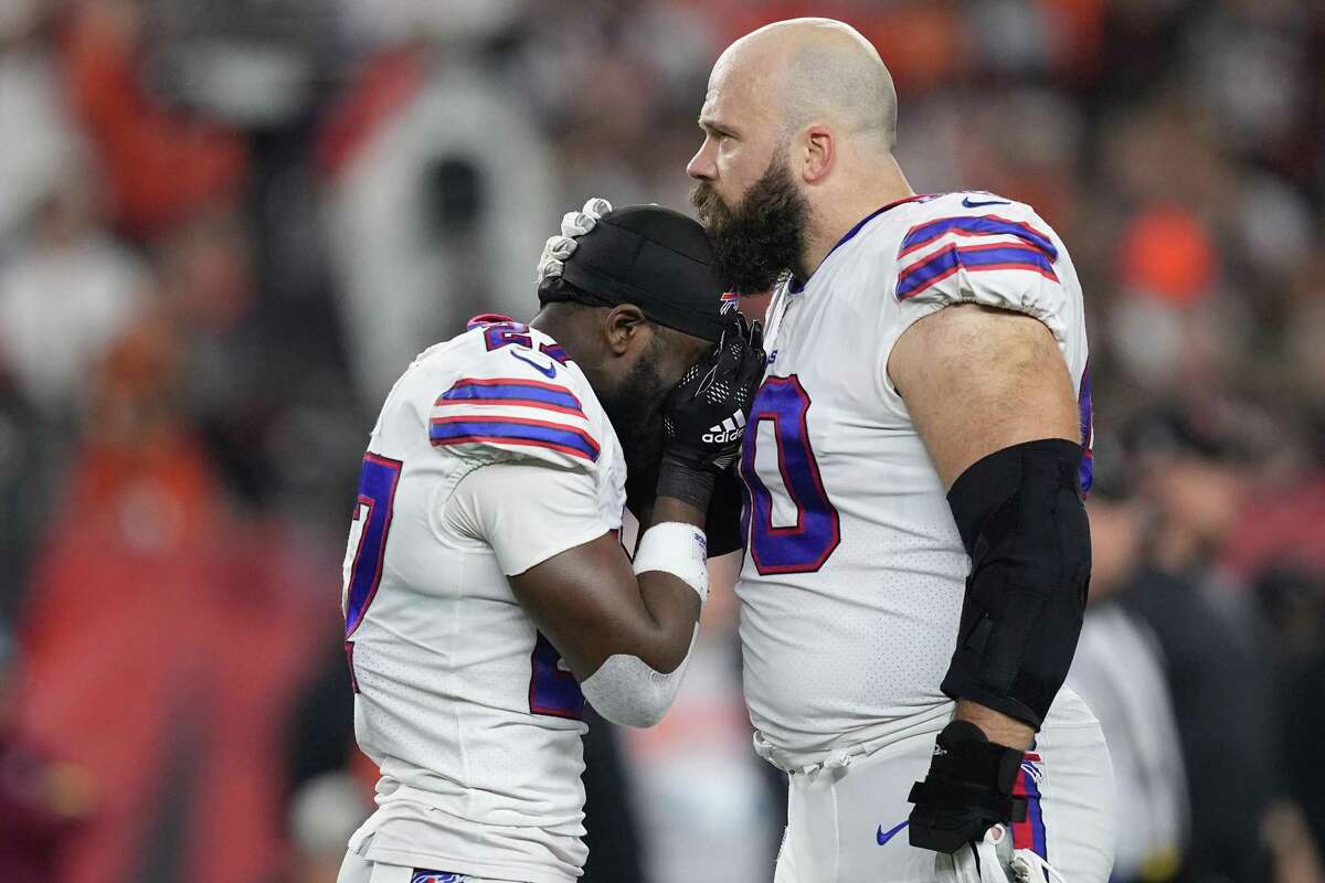 Tre'Davious White (27) and Mitch Morse (60) of the Buffalo Bills react to teammate Damar Hamlin (3) collapsing after making a tackle against the Cincinnati Bengals during the first quarter at Paycor Stadium on Monday, Jan. 2, 2023, in Cincinnati. (Dylan Buell/Getty Images/TNS)