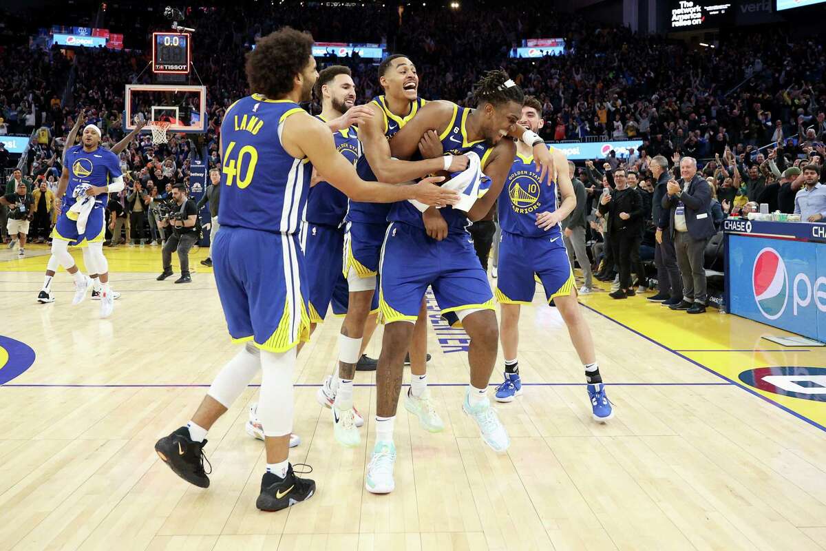 Kevon Looney gets swarmed by teammates after his game-winning put-back at the buzzer.