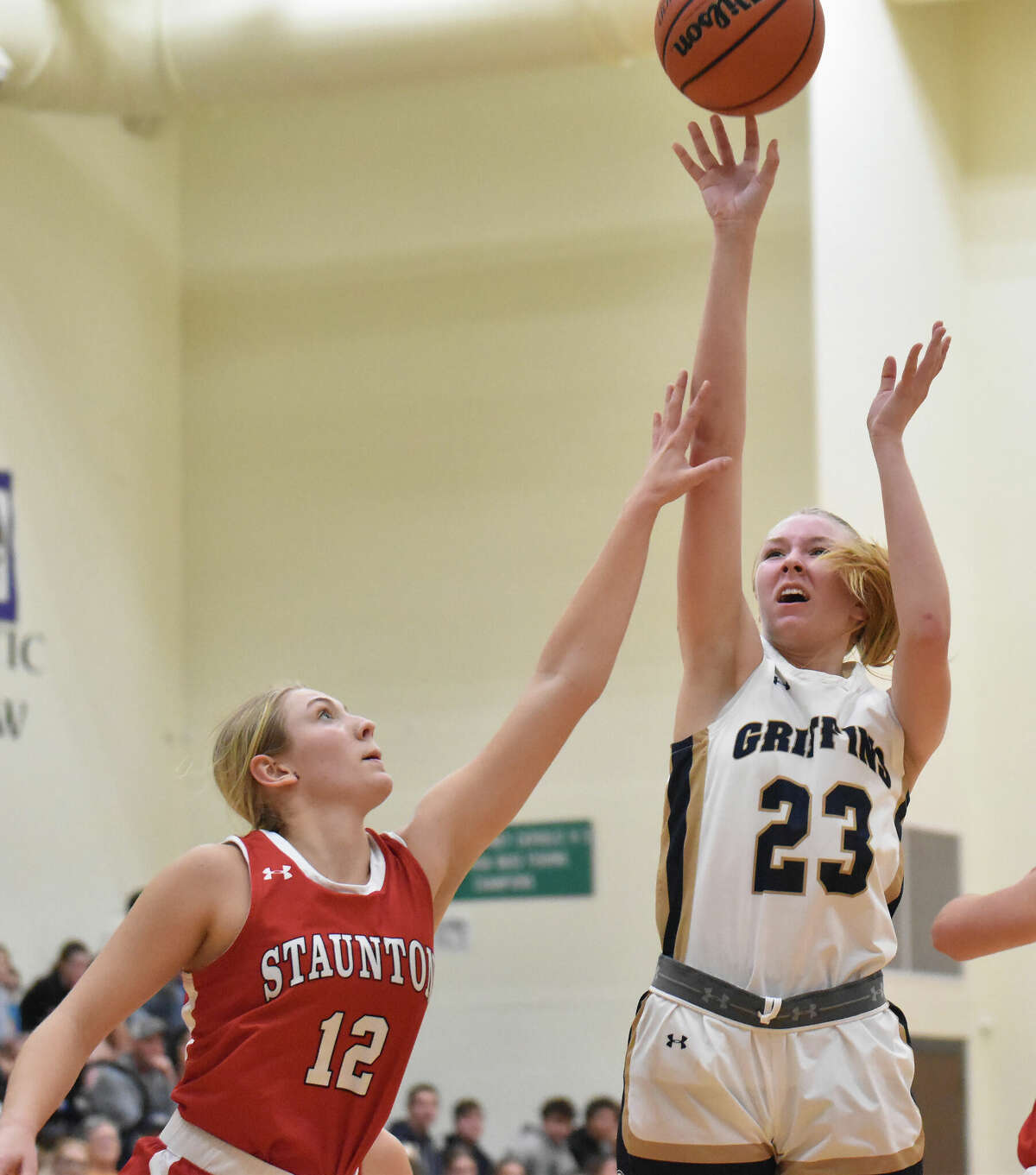 Father McGivney's Sami Oller puts up a shot over Staunton's Haris Legendre in the first half on Monday of a non-conference girls basketball game in Glen Carbon.