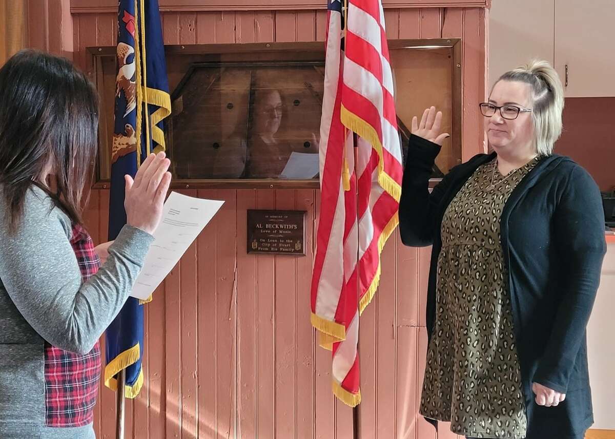 Andrea Grupido (right) takes the oath of office after being appointed to the position of city clerk by the Evart city council.