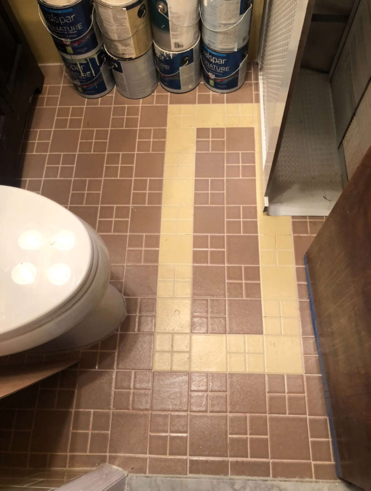Before: The two-tone tile floor in Caroline Mullen's bathroom in Queens.