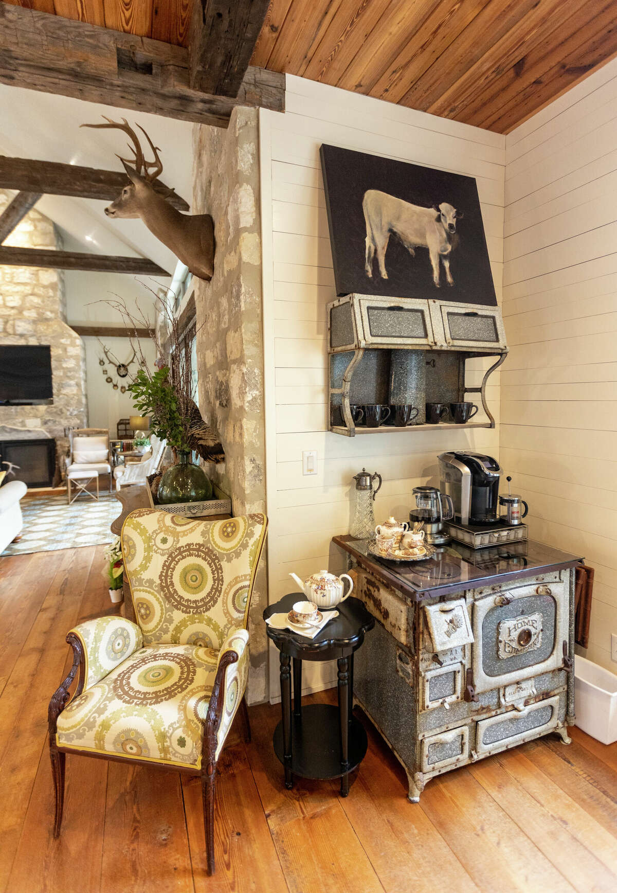 A coffee nook between the kitchen and living room is filled with antique pieces collected by the couple.