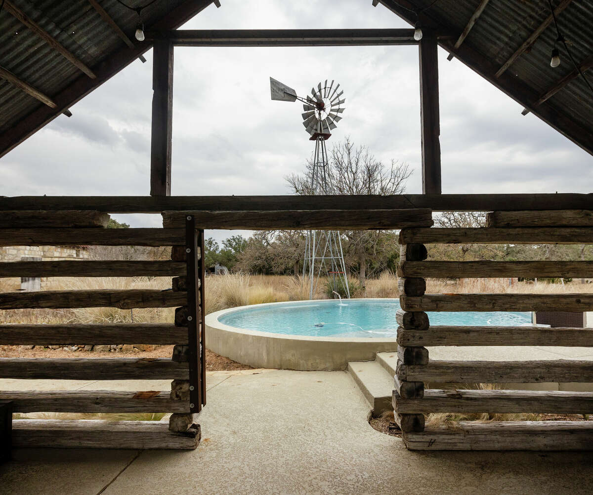 In the backyard they built a circular pool that looks strikingly like a large stock tank. Nearby, they rebuilt a century-old, one-room cabin they found in Oklahoma