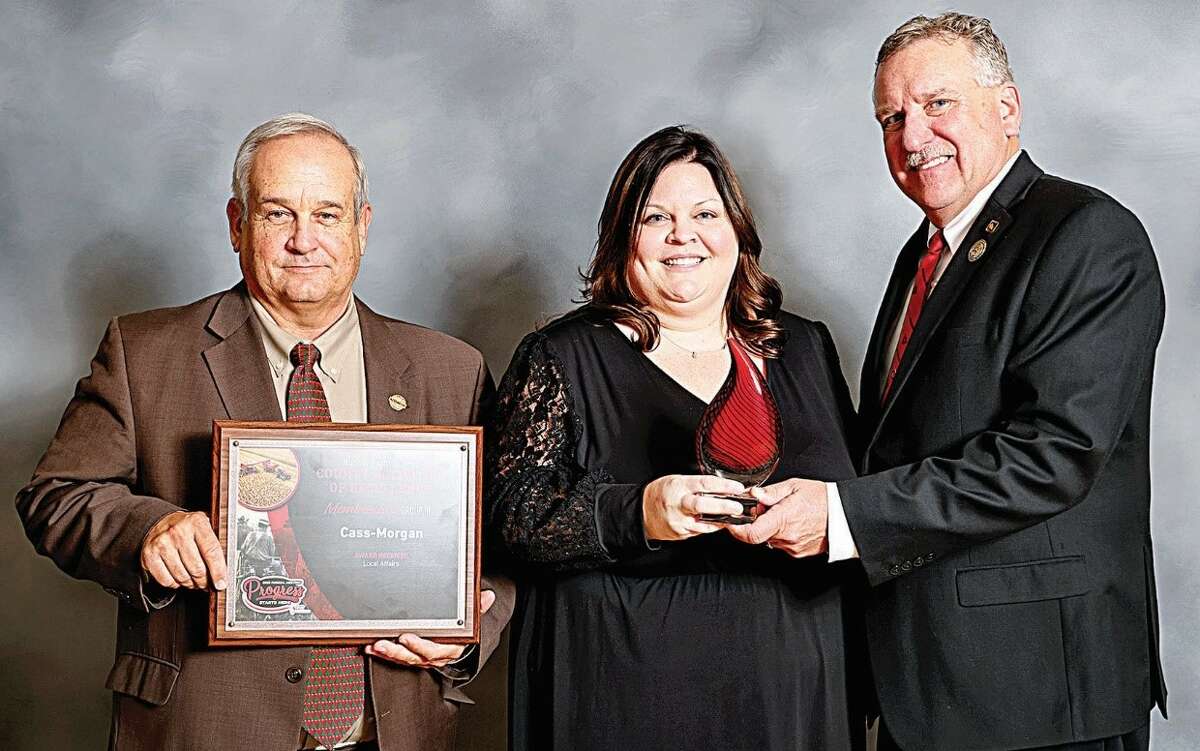 Receiving awards for excellence in programming from Illinois Farm Bureau Vice President Brian Duncan (right) are Cass-Morgan Farm Bureau President Dale Hadden and manager Lindsay Ryan.