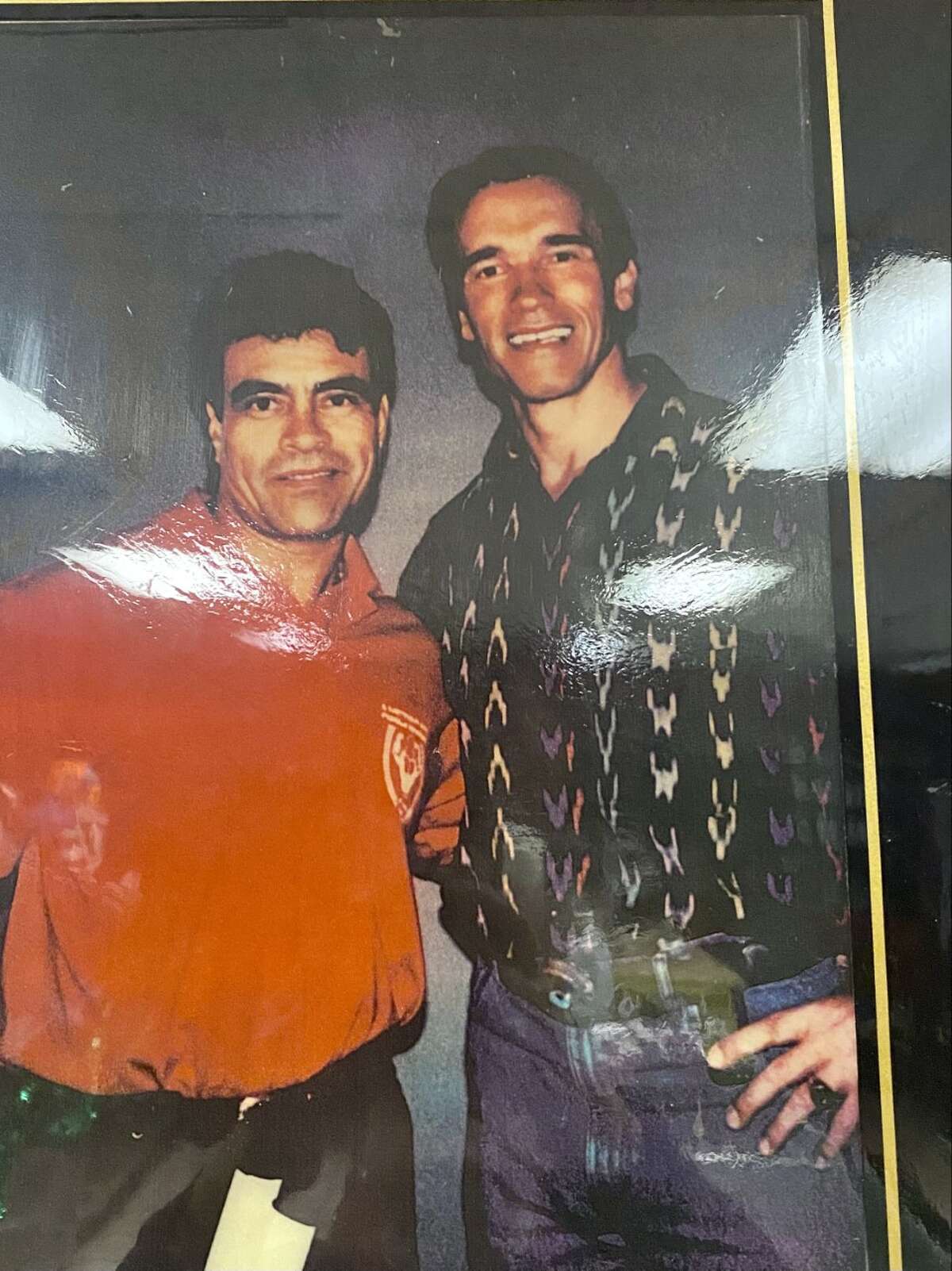 Santos Ramos poses for a photograph with Arnold Schwarzenegger.