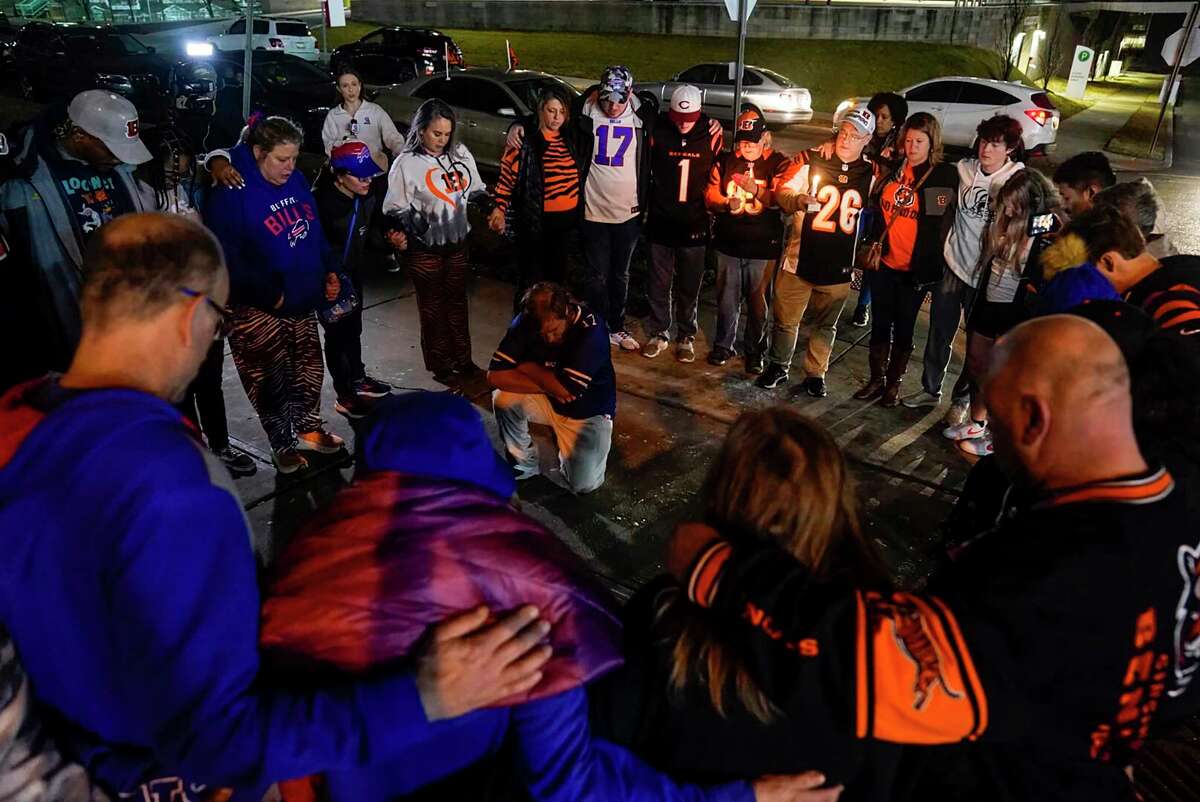 Fans gather outside University of Cincinnati Medical Center late Monday after Bills safety Damar Hamlin was taken there after collapsing during a game.