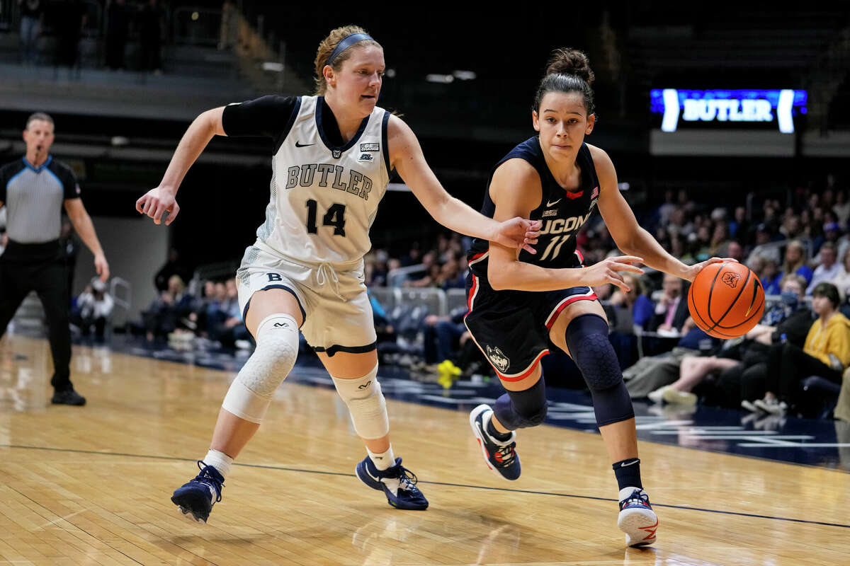 UConn forward Lou Lopez Senechal (11) drives on Butler forward Rachel McLimore (14) during the first half of an NCAA college basketball game in Indianapolis, Tuesday, Jan. 3, 2023. (AP Photo/Michael Conroy)