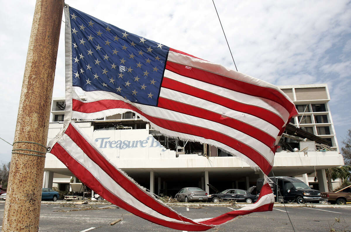 An American flag flies Tuesday, Aug. 30, 2005, in front of the heavily damaged Treasure Bay's hotel in Biloxi, Miss., following Hurricane Katrina.