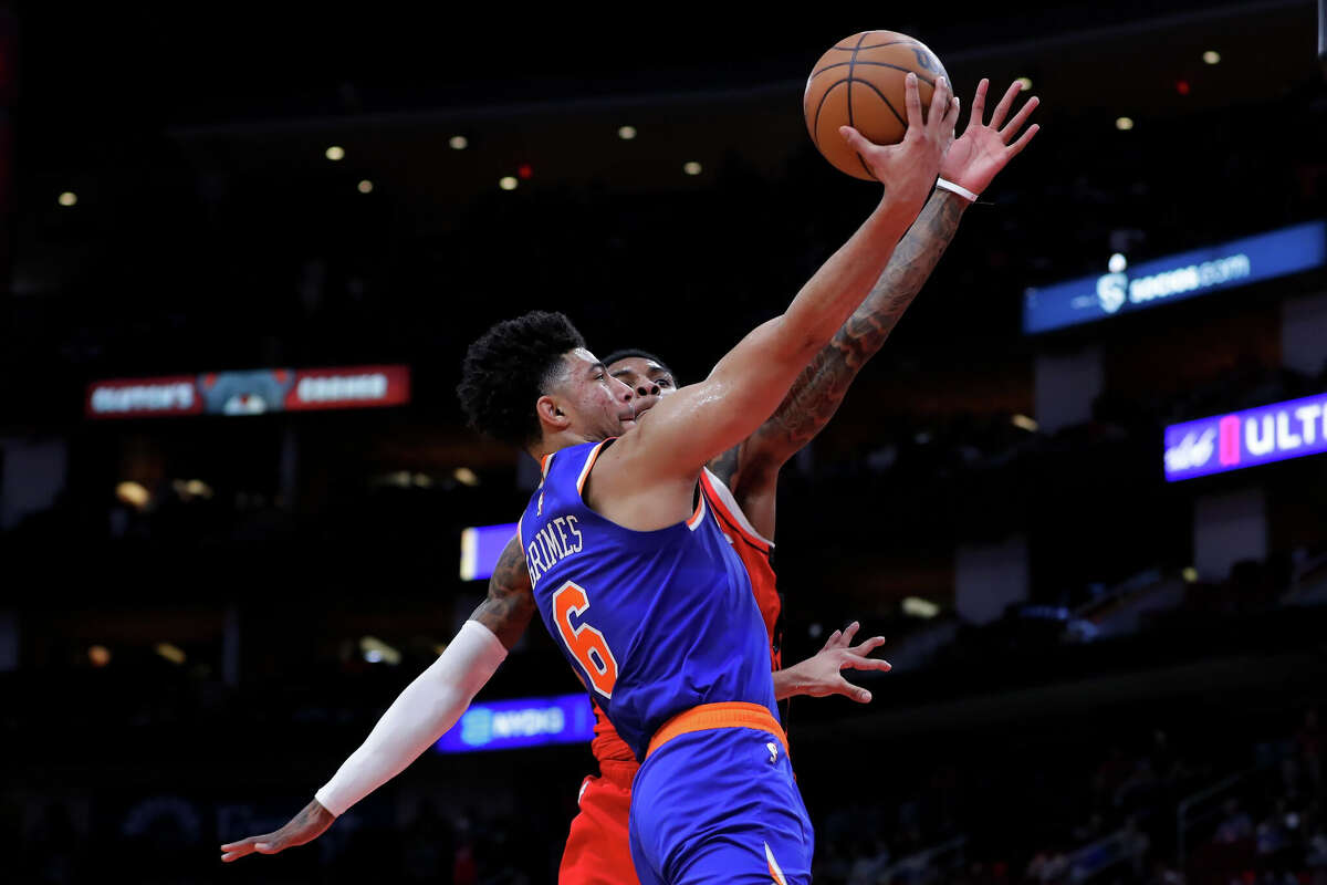 New York Knicks guard Quentin Grimes (6) lays up a shot in front of Houston Rockets guard Kevin Porter Jr., back, during the first half of an NBA basketball game Saturday, Dec. 31, 2022, in Houston. (AP Photo/Michael Wyke)