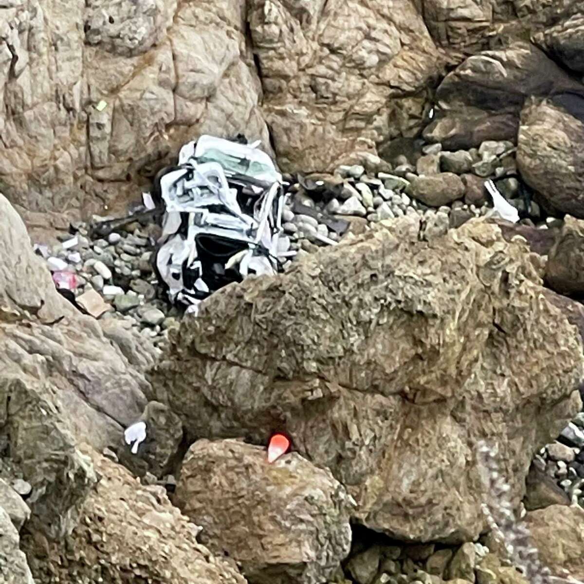 FILE - This image from video provided by San Mateo County Sheriff's Office shows a Tesla vehicle that plunged off the Pacific Coast Highway, Monday, Jan. 2, 2023, near Devil's Slide, leaving four people in critical condition, a fire official said. The driver of the Tesla that plunged off a cliff in Northern California, seriously wounding two children and his wife, has been charged with attempted murder. (San Mateo County Sheriff's Office via AP, File)