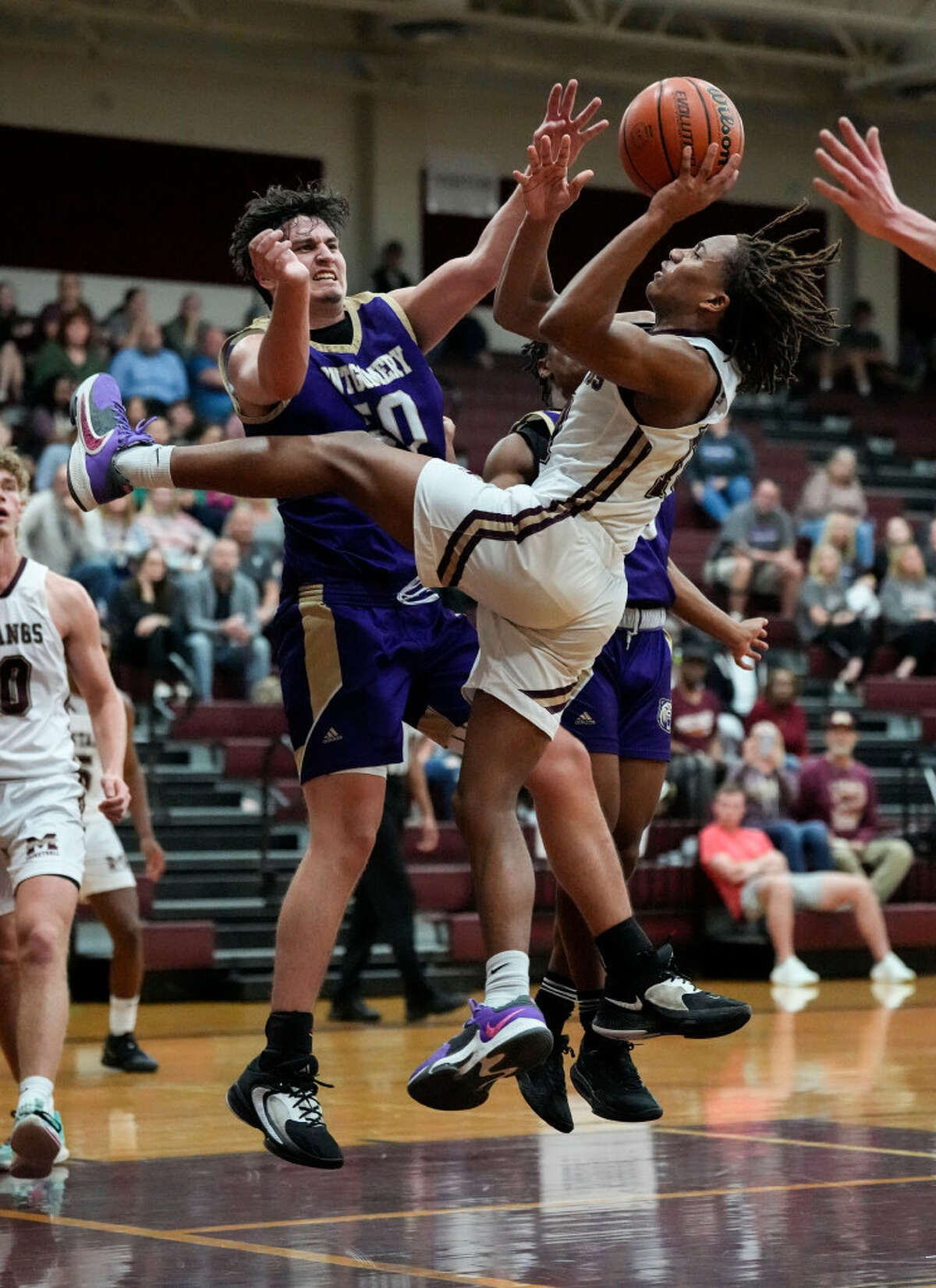 Magnolia West shooting guard Xavier Portalis (10) goes up to the basket against Montgomery center RJ Kime (50) during the second half of a District 21-5A boys basketball game at Magnolia West High School on Tuesday, Jan. 3, 2023 in Magnolia.