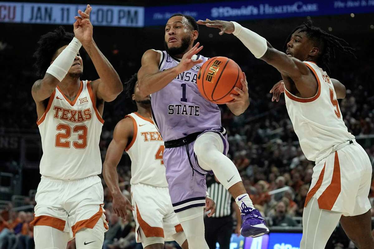 Kansas State guard Markquis Nowell (1) drives to the basket past Texas forward Dillon Mitchell (23) and guard Marcus Carr (5) during the first half of an NCAA college basketball game in Austin, Texas, Tuesday, Jan. 3, 2023. (AP Photo/Eric Gay)