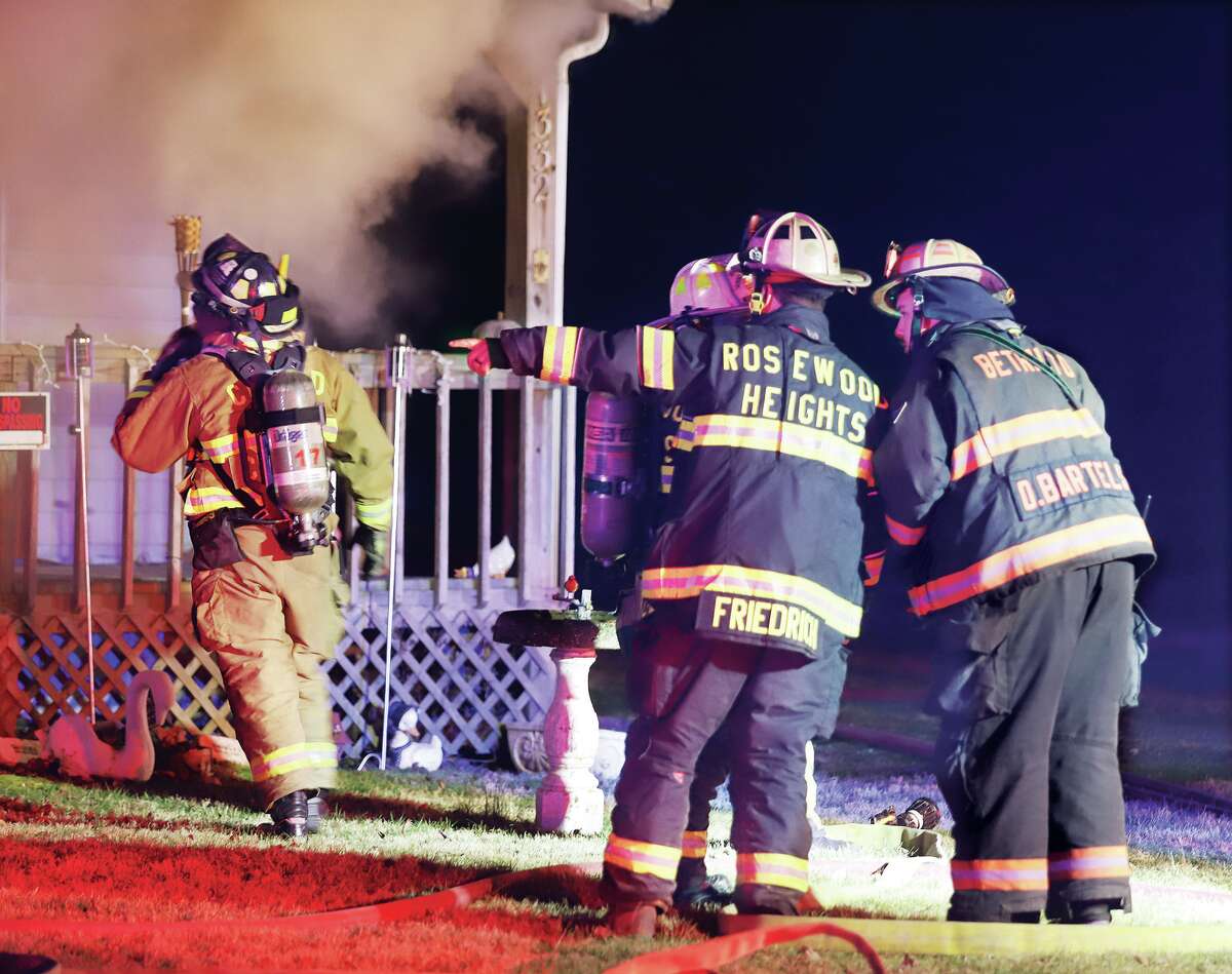 John Badman|The Telegraph Fire chiefs coordinate their attack on a fire that extensively damaged a house late Tuesday in the 1300 block of Deanna Avenue in Cottage Hills.