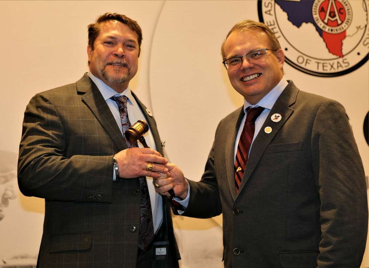 Stacey Bryant (left) of Midland, a principal and general manager of Jones Bros. Dirt and Paving Contractors, was installed as president of the Associated General Contractors of Texas Wednesday during a ceremony at the Hyatt Regency in Austin. Bryant accepts the leadership gavel from 2022 AGC President David Casteel.
