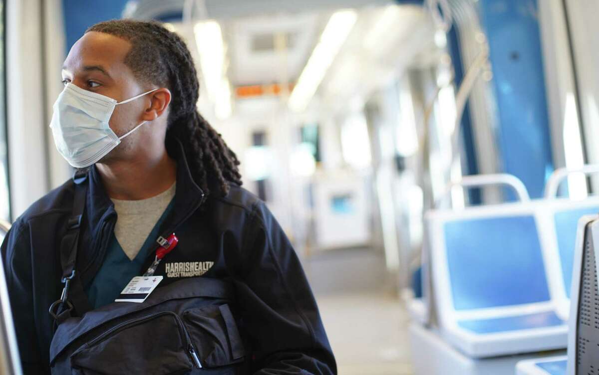 Micah Bradford wears a mask as he rides the Metro to work through downtown Houston on Wednesday, Jan. 4, 2023. Bradford has remained diligent wearing his mask, especially when taking public transportation. A new variant, XBB1.5, is quickly making inroads in the United States. Meanwhile, the positivity rate in the Texas Medical Center jumped last week from 8.1 percent to 11.1 percent.