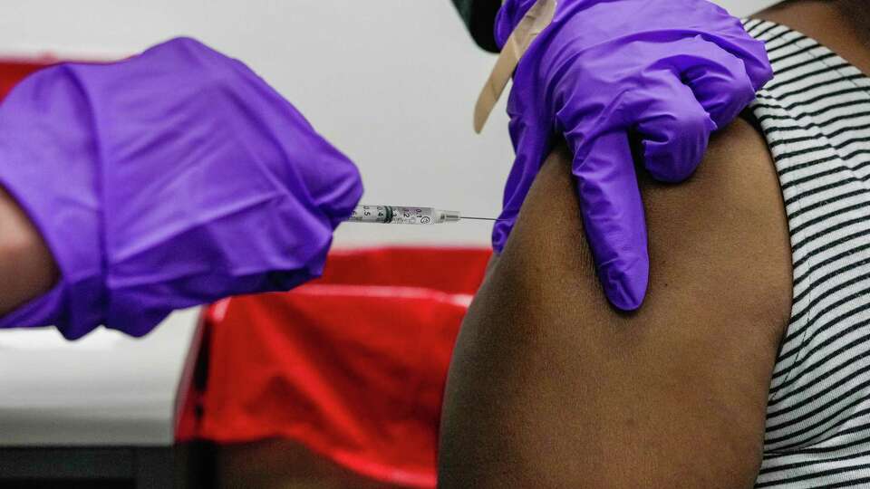 Elementary school teacher, Janet Baldwin receives a Covid booster shot on Wednesday, Jan. 4, 2023 at Houston Health Department's Northside Health Center in Houston. Janet shared 