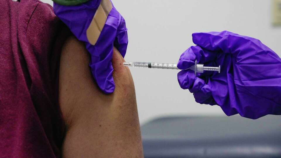 Nurse, Mary Khuat injects Hector Cuevas with his first Covid vaccine on Wednesday, Jan. 4, 2023 at Houston Health Department's Northside Health Center in Houston.