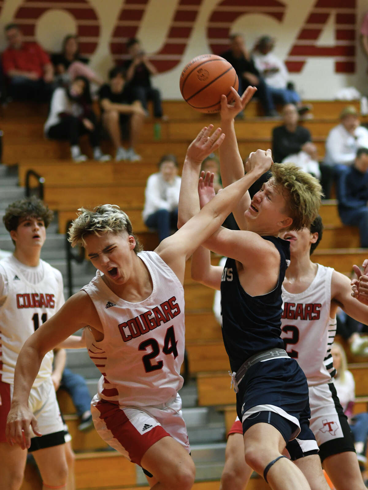 Tomball Memorial junior forward Luke Reder, right, runs into a foul by Tomball senior center Collin Frank (24) on his way to the hoop during the third quarter of their District 15-6A matchup at Tomball High School on Wednesday, Jan. 4, 2023.