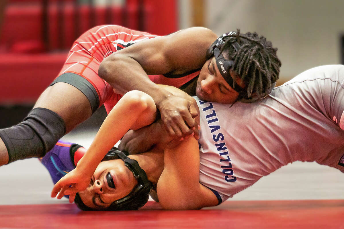 Alton's William Harris defeats Collinsville's Adrian Beard Wednesday night at Alton High in the first Southwestern conference dual matchup in the school's new auxiliary gym facility.
