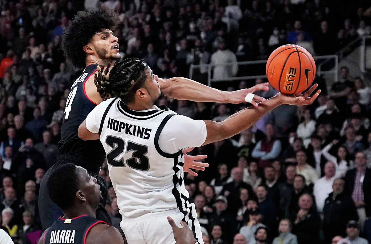 Providence forward Bryce Hopkins (23) drives to the basket against UConn guard Andre Jackson Jr. (44) during the second half of an NCAA college basketball game, Wednesday, Jan. 4, 2023, in Providence, R.I. Providence won 73-61. (AP Photo/Charles Krupa)