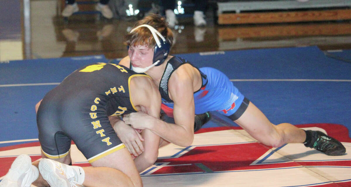 Chippewa Hills' Tyler Saxton (right) works at getting the edge on his opponent in Thursday night action. Saxton won a decision.