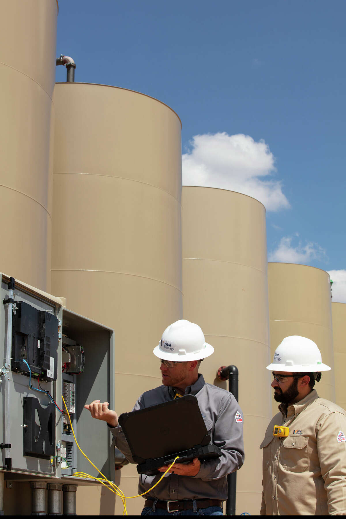 Laredo Petroleum technicians at one of the company's Permian Basin production sites. Laredo will rebrand itself as Vital Energy beginning January 9.