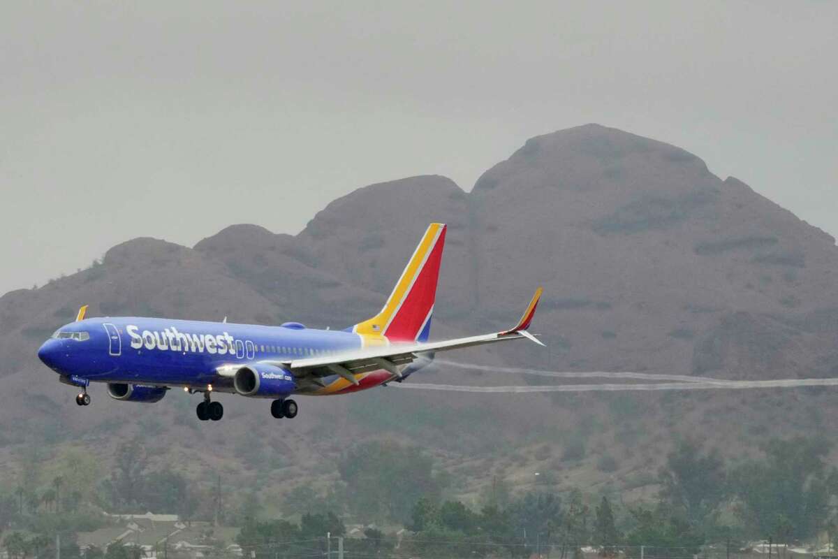 FILE - A Southwest Airlines jet arrives at Sky Harbor International Airport, Dec. 28, 2022, in Phoenix. With its flights now running on a roughly normal schedule, Southwest Airlines is turning its attention to luring back customers and repairing damage to a reputation for service after canceling 15,000 flights around Christmas. The disruptions started with a winter storm and snowballed when Southwest's ancient crew-scheduling technology failed.