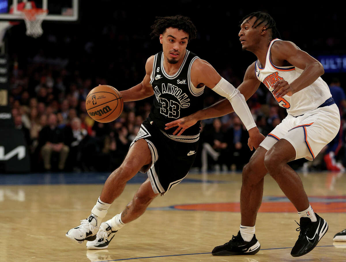 No. 33 Tre Jones of the San Antonio Spurs heads for goal as No. 5 Immanuel Quickley of the New York Knicks defends during the first half at Madison Square Garden on January 4, 2023 in New York City.