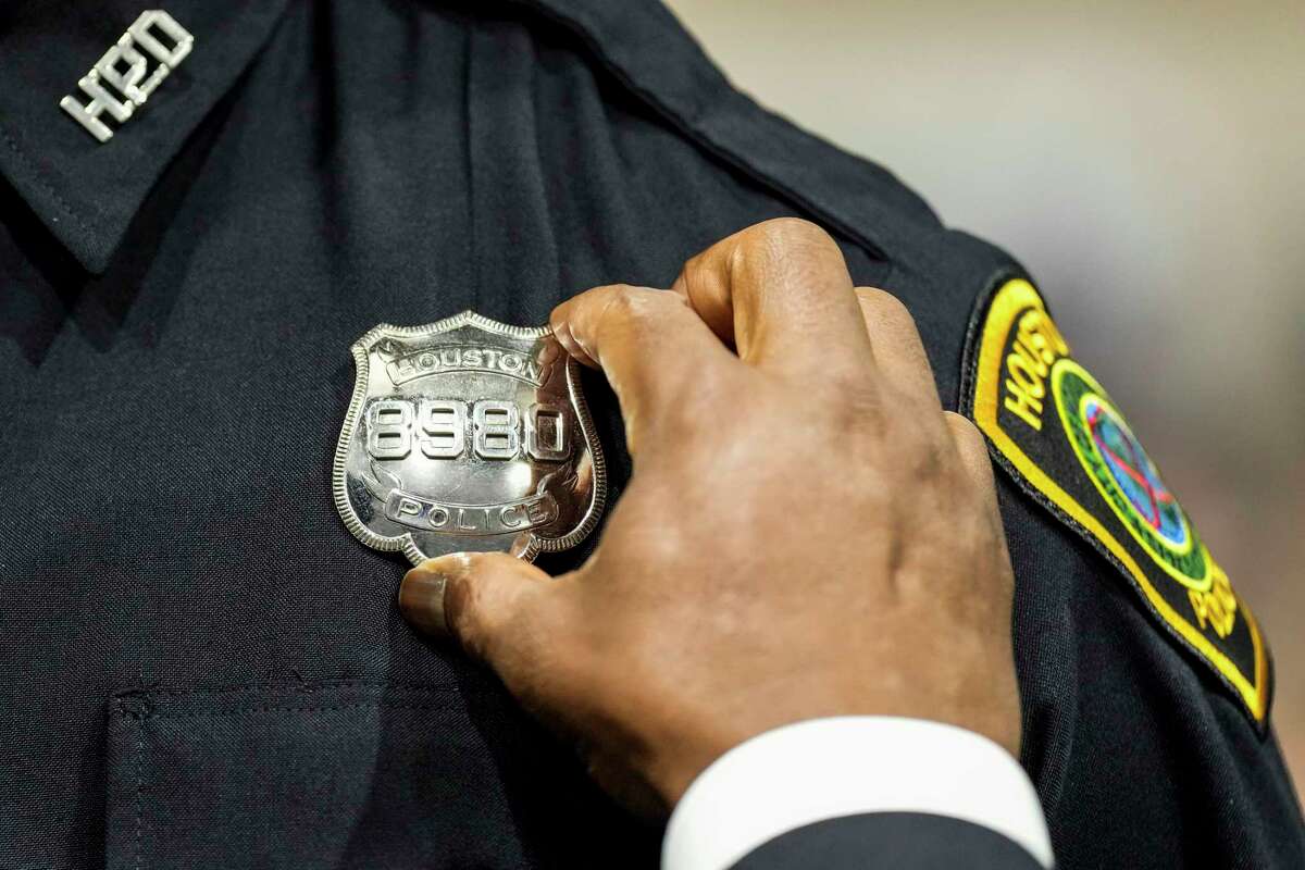 Demontrey Terrell has his badge pinned on his uniform by Chief Troy Finner during the Houston Police Academy graduation of Cadet Class 256 on Thursday, Jan. 5, 2023 in Houston.