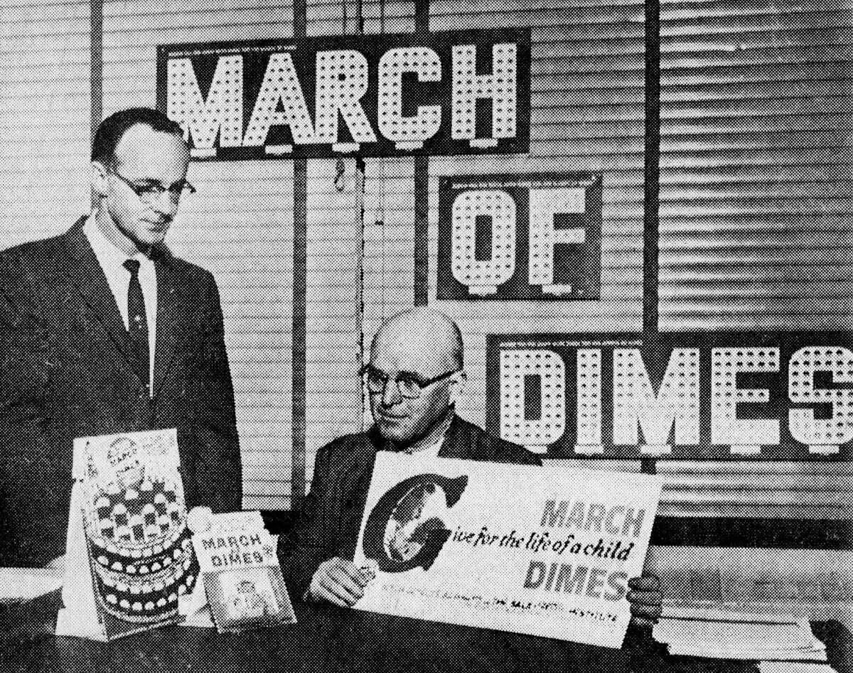 The 1963 March of Dimes campaign got underway this morning as campaign vice chair Les Bowling (left) and campaign chair Phil Lanz look over collection cards, canisters and display posters to be used in the drive. The photo was published in the News Advocate on Jan. 7, 1963.