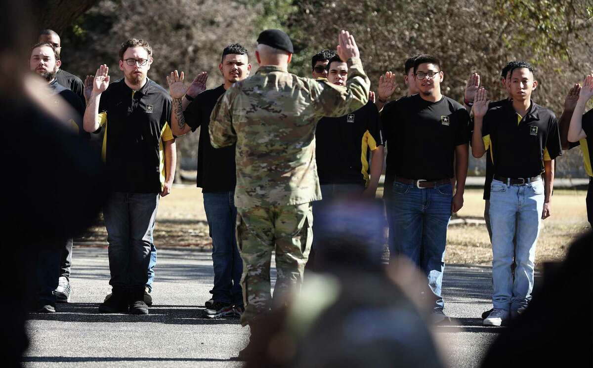 Enlistees raise their hands to take the oath of enlistment as U.S. Army North, which began as the 5th United States Army, marks its 80th birthday on Thursday, Jan. 5, 2023 with a ceremony full of pomp and circumstance at its historic headquarters in the Quadrangle at Fort Sam.