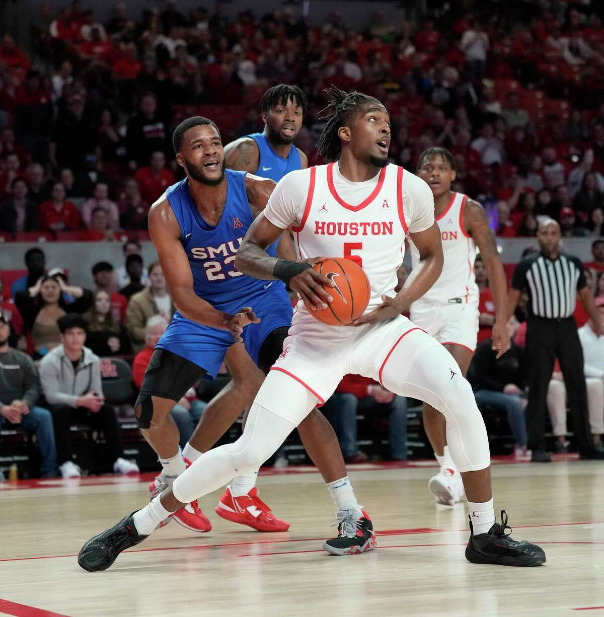 Houston Cougars forward Ja'Vier Francis (5) works against Southern Methodist Mustangs forward Efe Odigie (23) under the basket during the first half of a NCAA mens basketball game at the Fertitta Center on Thursday, Jan. 5, 2023 in Houston.