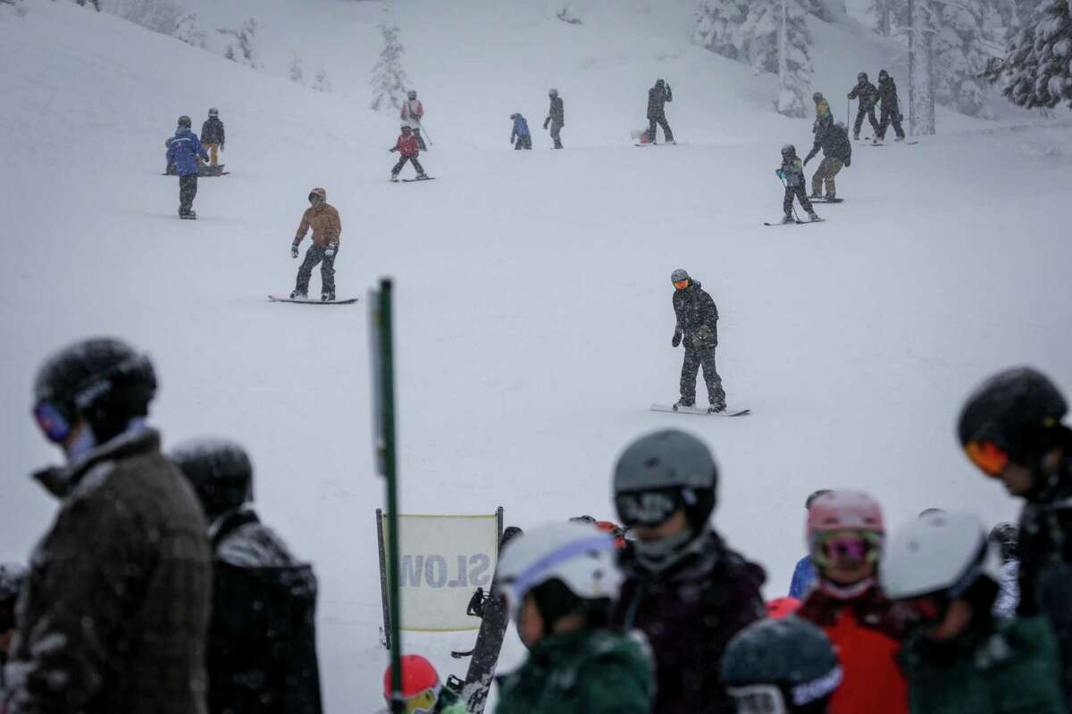 Skiers and snowboarders make their way toward California Lodge at Heavenly Mountain Resort in South Lake Tahoe.