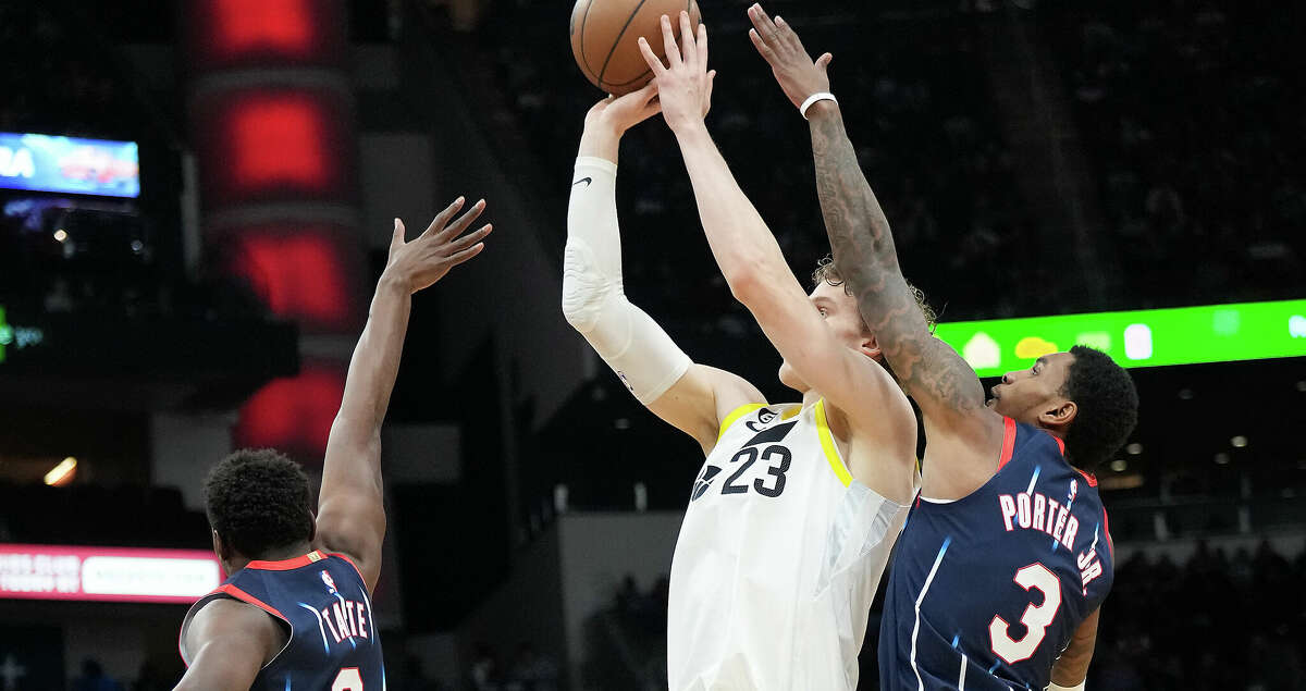Utah Jazz forward Lauri Markkanen (23) puts up a shot between Houston Rockets Jae'Sean Tate (8) and Kevin Porter Jr. (3) in the first half at the Toyota Center on Thursday, Jan. 5, 2023 in Houston.