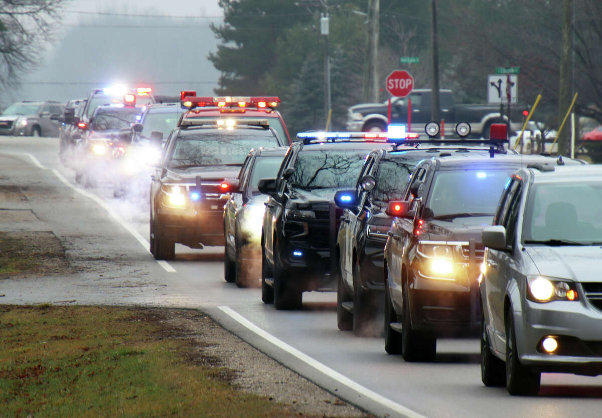 A funeral procession with patrol vehicles from law enforcement agencies in Huron and Saginaw counties makes its way down Barrie Road to Colfax Cemetery on Friday. The procession was for retired Michigan State Police Trooper Lawrence 'Larry' Verga Jr., who passed away Jan. 1 at the age of 60. Verga was assigned to the MSP Bad Axe post during his 30 years with the agency.
