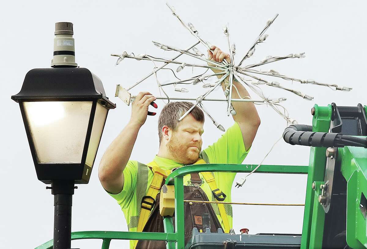 John Badman|The Telegraph Wood River Public Works employees were dealing with a little down time Tuesday as they began taking down the Christmas decorations on E. Ferguson Avenue.