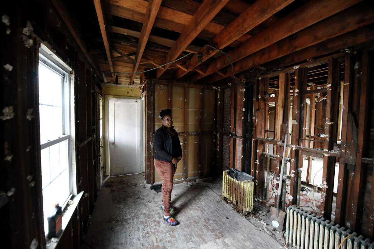 Home owner Euphrasia Kippins walks through the house she purchased through Albany County Land Bank and is in the process of renovating on Friday, Jan. 6, 2023, in Albany, N.Y.